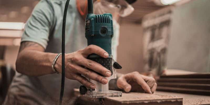 Man Using Router on Wood Project