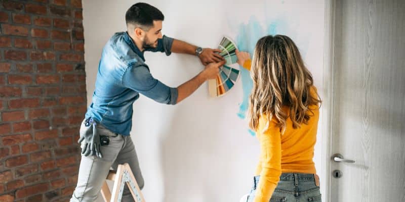 Couple Testing Paint Colors on Wall