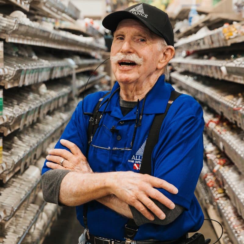 Employee Standing in Plumbing Fittings Aisle