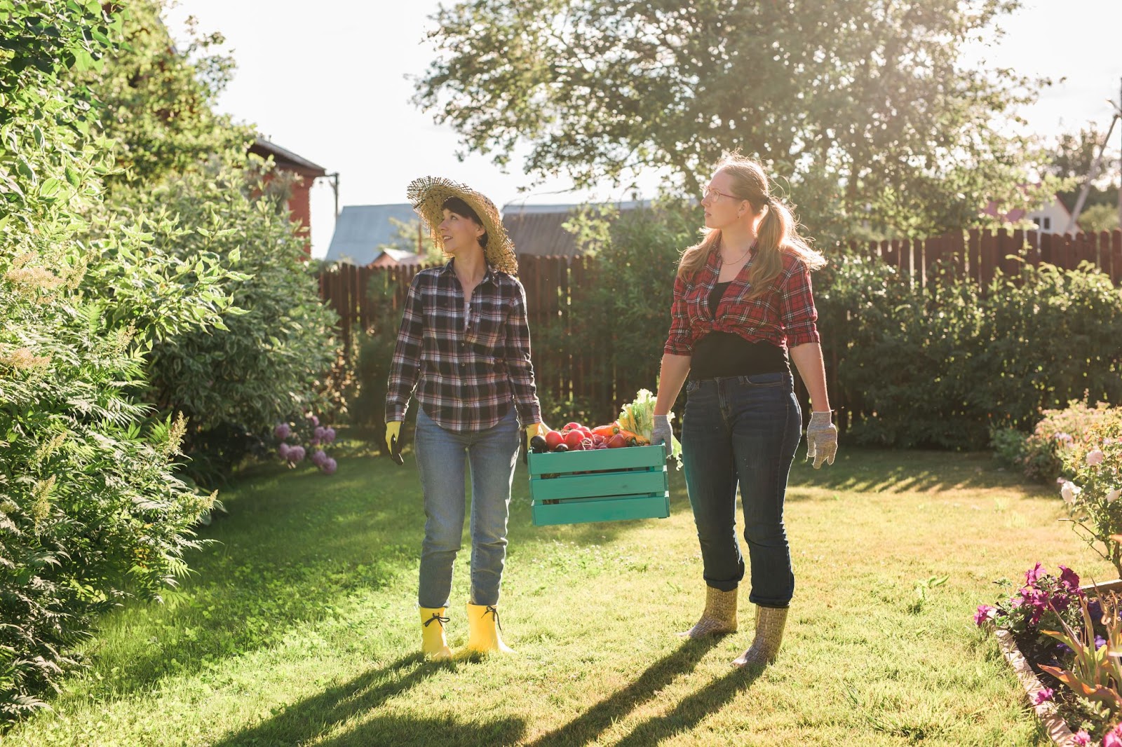 Friends Carrying Freshly Harvested Fruits & Veggies From Garden