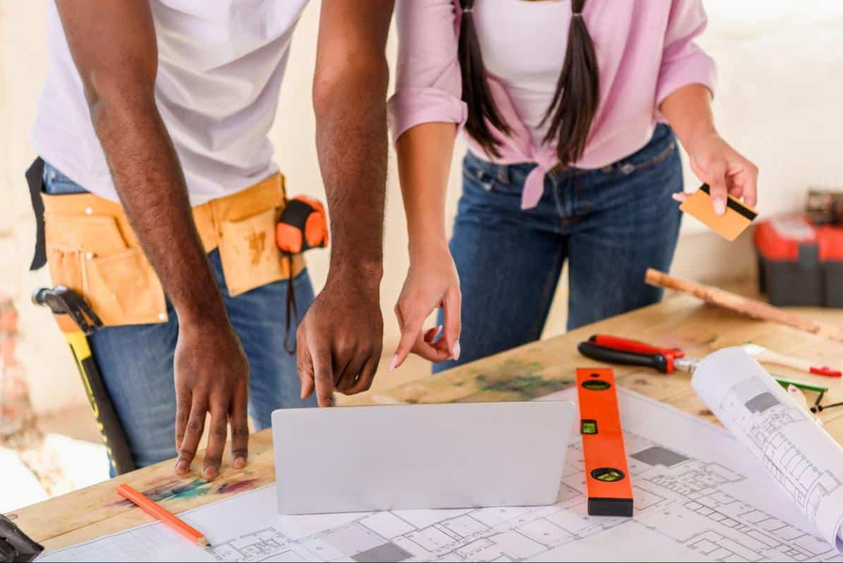 A Couple Planning their DIY project on a table