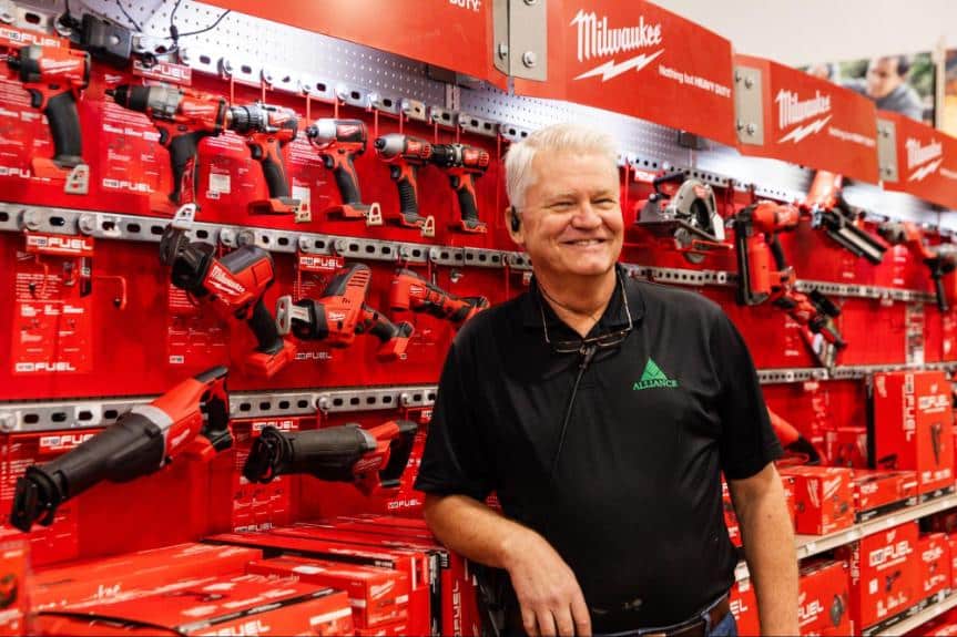 BFS Alliance employee in front of a Milwaukee tool display